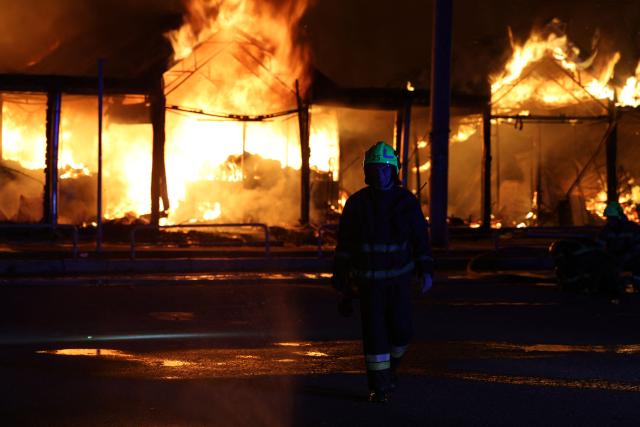 A Ukrainian rescuer works at the site of a Russian strike in Kyiv on August 16, 2026, amid the Russian invasion of Ukraine. Russian strikes killed one person and wounded at least seven others in Ukraine, authorities said August 16, while Moscow officials reported downing more than 100 drones heading towards the capital. (Photo by AFP)