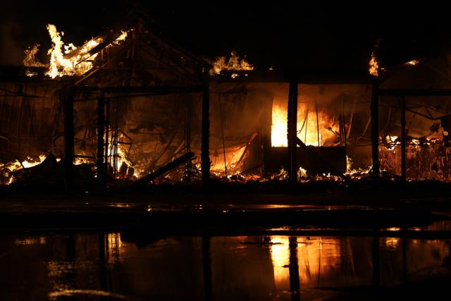 This photograph shows a book market engulfed in flames following a Russian strike in Kyiv on August 16, 2026, amid the Russian invasion of Ukraine. Russian strikes killed one person and wounded at least seven others in Ukraine, authorities said August 16, while Moscow officials reported downing more than 100 drones heading towards the capital. (Photo by AFP)