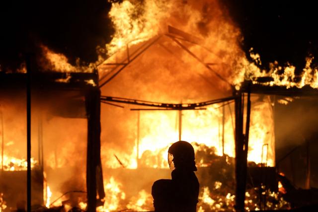 A Ukrainian rescuer works at the site of a Russian strike in Kyiv on August 16, 2026, amid the Russian invasion of Ukraine. Russian strikes killed one person and wounded at least seven others in Ukraine, authorities said August 16, while Moscow officials reported downing more than 100 drones heading towards the capital. (Photo by AFP)