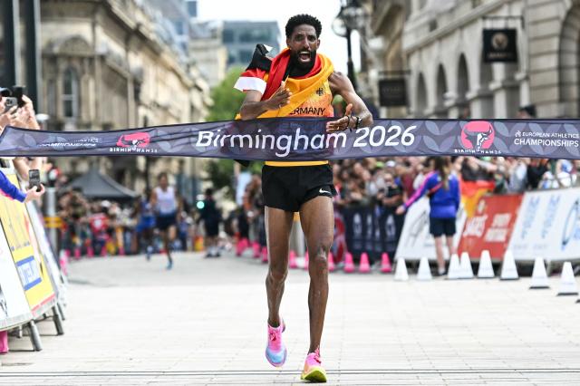 Germany's Amanal Petros celebrates as he crosses the finish line to win the men's marathon during the European Athletics Championships in Birmingham on August 16, 2026. (Photo by Paul ELLIS / AFP)