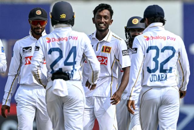 Sri Lanka's Keshara Nuwantha (C) celebrates with teammates after taking the wicket of India's KL Rahul during the second day of the first Test cricket match between Sri Lanka and India at the Galle International Stadium in Galle on August 16, 2026. (Photo by Ishara S. KODIKARA / AFP)