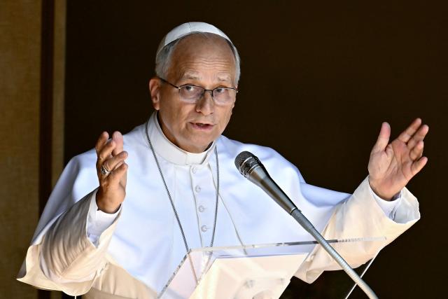 Pope Leo XIV delivers his blessing to the faithful gathered in Piazza della Libertà in front of the Apostolic Palace during the Angelus prayer in Castel Gandolfo on August 16, 2026. (Photo by Filippo MONTEFORTE / AFP)