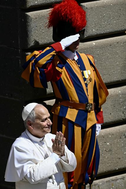 ope Leo XIV acknowledges the faithful gathered in Piazza della Libertà in front of the Apostolic Palace in Castel Gandolfo during the Angelus prayer on August 16, 2026. (Photo by Filippo MONTEFORTE / AFP)