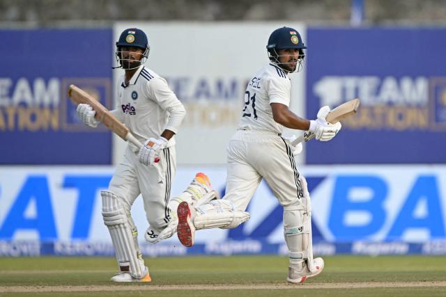 India's Manav Suthar (L) and Dhruv Jurel run between the wickets during the second day of the first Test cricket match between Sri Lanka and India at the Galle International Stadium in Galle on August 16, 2026. (Photo by Ishara S. KODIKARA / AFP)