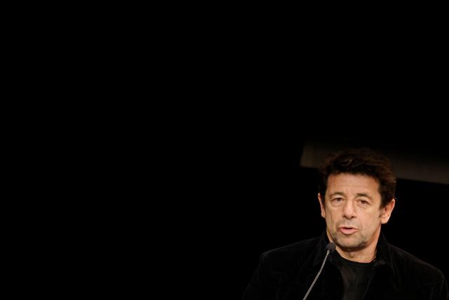 (FILES) French singer-songwriter Patrick Bruel speaks on stage during an evening against the rise of anti-semitism in Europe, organised by the "Regle du Jeu" magazine, the Representative Council of French Jewish Institutions (CRIF) and other French institutions, at the Theatre Antoine, in Paris on June 3, 2024. The French singer and actor Patrick Bruel, who is under investigation for rape and sexual assault, has been allowed to leave France after the conditions of his bail were relaxed, the Nanterre public prosecutors office confirmed on August 15, 2026, corroborating a report by Mediapart. (Photo by GEOFFROY VAN DER HASSELT / AFP)