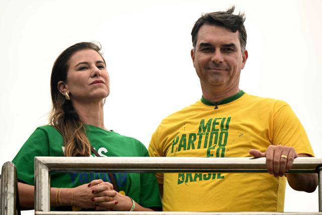 Brazil's right-wing presidential candidate and senator Flavio Bolsonaro and his wife Fernanda attend a campaign rally at Copacaban beach in Rio de Janeiro, Brazil, on August 16, 2026. Brazilians will go to the polls next October 4 once again deeply polarized and under the shadow of U.S. President Donald Trump, who has backed conservative candidates in recent elections in Latin America. (Photo by MAURO PIMENTEL / AFP)