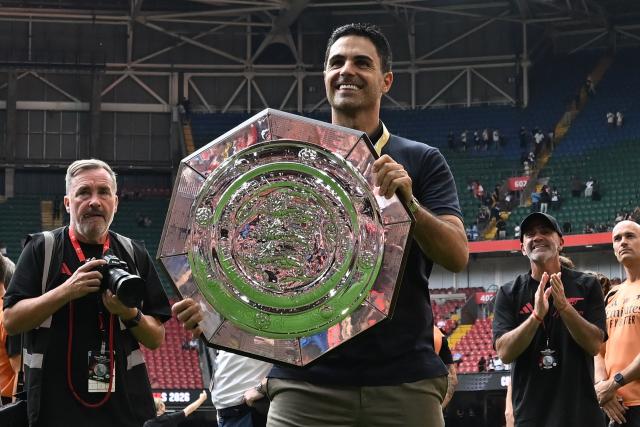 Arsenal's Spanish manager Mikel Arteta celebrates with the trophy on the pitch after their victory in the English FA Community Shield football match between Arsenal and Manchester City at The Principality Stadium, in Cardiff, south Wales on August 16, 2026. Arsenal won the game 3-0. (Photo by Glyn KIRK / AFP)