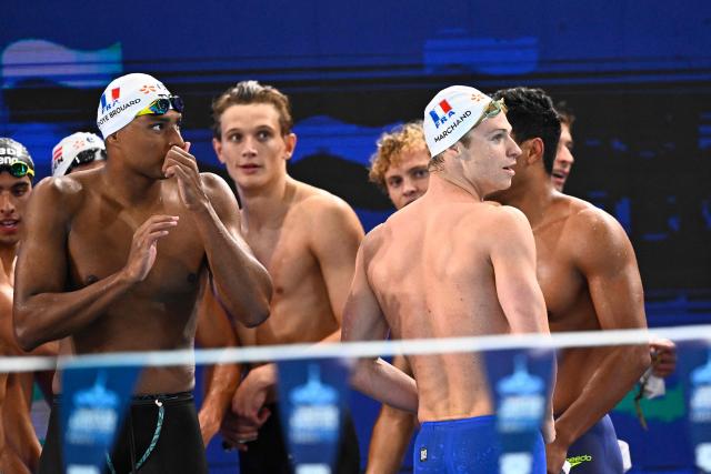 France's Yohann Ndoye-Brouard (L) and France's Leon Marchand react at the end of the final of the men's 4x100m medley relay swimming event during the LEN European Aquatics Championships at the Olympic Aquatic Centre in Saint-Denis, northern suburbs of Paris, on August 16, 2026. (Photo by JULIEN DE ROSA / AFP)
