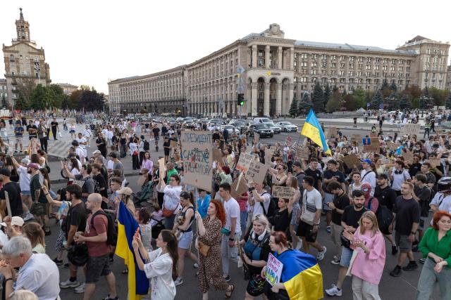 Protesters carry placards as they march during a rally calling for a reform of the defence sector and the reinstatement of the young and tech-savvy defence minister Mykhailo Fedorov, who was sacked a mounth ago, in central Kyiv on August 16, 2026, amid the Russian invasion of Ukraine. Fedorov, 35, was appointed in January on a mandate to modernise and digitise the Ukrainian military but was removed after months of behind-the-scenes clashes with the army command, who he said resisted his calls to change. His removal triggered a wave of protests that pushed President Volodymyr Zelensky to also replace army’s commander Oleksandr Syrsky, seen as Fedorov’s rival. (Photo by Serhii Okunev / AFP)