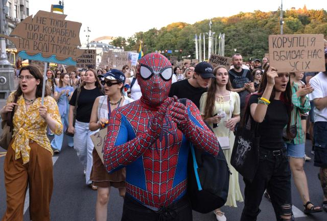 A protester dressed as Spideman chants as they take part in a rally calling for a reform of the defence sector and the reinstatement of the young and tech-savvy defence minister Mykhailo Fedorov, who was sacked a mounth ago, in central Kyiv on August 16, 2026, amid the Russian invasion of Ukraine. Fedorov, 35, was appointed in January on a mandate to modernise and digitise the Ukrainian military but was removed after months of behind-the-scenes clashes with the army command, who he said resisted his calls to change. His removal triggered a wave of protests that pushed President Volodymyr Zelensky to also replace army’s commander Oleksandr Syrsky, seen as Fedorov’s rival. (Photo by Serhii Okunev / AFP)