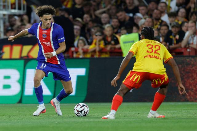 PSG's French forward #11 Maghnes Akliouche (L) fights for the ball with Lens' French defender #32 Kyllian Antonio during the French Super Cup (Trophee des Champions) football match between RC Lens and Paris Saint-Germain (PSG) at the Stade Bollaert-Delelis in Lens, northern France on August 16, 2026. (Photo by GEOFFROY VAN DER HASSELT / AFP)