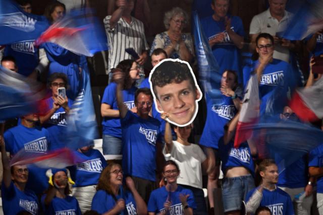 French supporters, one holding a portrait of France's Leon Marchand, cheer ahead of the final of the men's 4x100m medley relay swimming event during the LEN European Aquatics Championships at the Olympic Aquatic Centre in Saint-Denis, northern suburbs of Paris, on August 16, 2026. (Photo by SEBASTIEN BOZON / AFP)