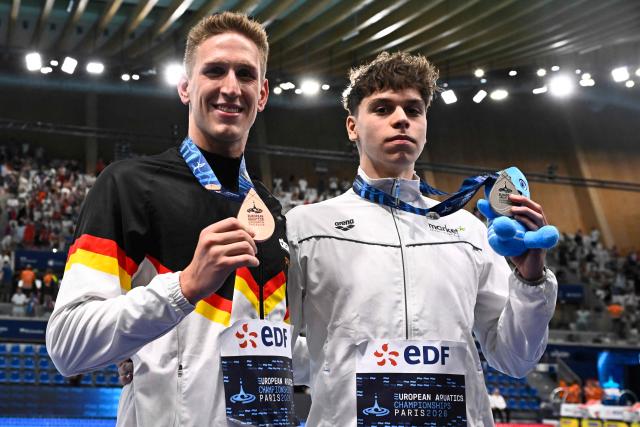 Germany's Lukas Martens (bronze medal) and Hungary's Lukas Papai (silver medal) pose on the podium of the men's 400m freestyle swimming event during the LEN European Aquatics Championships at the Olympic Aquatic Centre in Saint-Denis, northern suburbs of Paris, on August 16, 2026. (Photo by JULIEN DE ROSA / AFP)