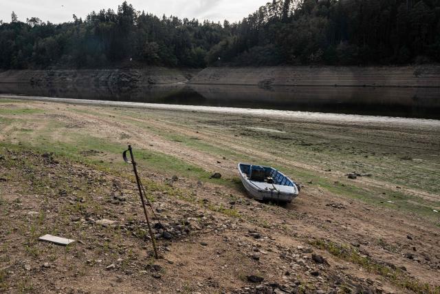 A boat is seen  on the bank of water reservoir Orlík - part of the Vltava Moldau river  near Podolsko village on August 16, 2026 as water levels of the Vltava - Moldau river  have reached historic lows for almost last 65 years. (Photo by Michal Cizek / AFP)