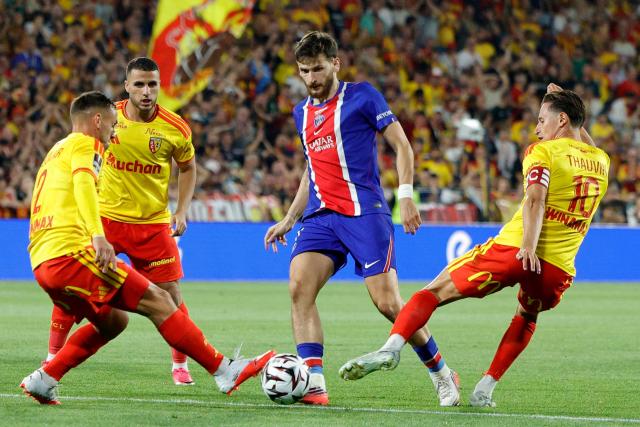 PSG's Georgian forward #07 Khvicha Kvaratskhelia (C) fights for the ball with Lens' French defender #02 Ruben Aguilar (L) and Lens' French forward #10 Florian Thauvin (R) during the French Super Cup (Trophee des Champions) football match between RC Lens and Paris Saint-Germain (PSG) at the Stade Bollaert-Delelis in Lens, northern France on August 16, 2026. (Photo by GEOFFROY VAN DER HASSELT / AFP)
