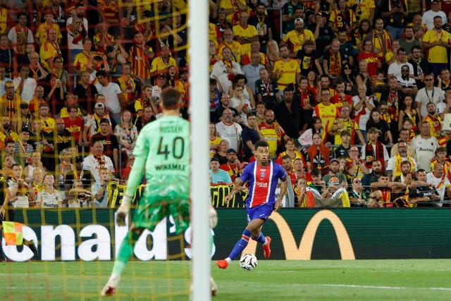 PSG's French forward #14 Desire Doue runs with the ball during the French Super Cup (Trophee des Champions) football match between RC Lens and Paris Saint-Germain (PSG) at the Stade Bollaert-Delelis in Lens, northern France on August 16, 2026. (Photo by GEOFFROY VAN DER HASSELT / AFP)