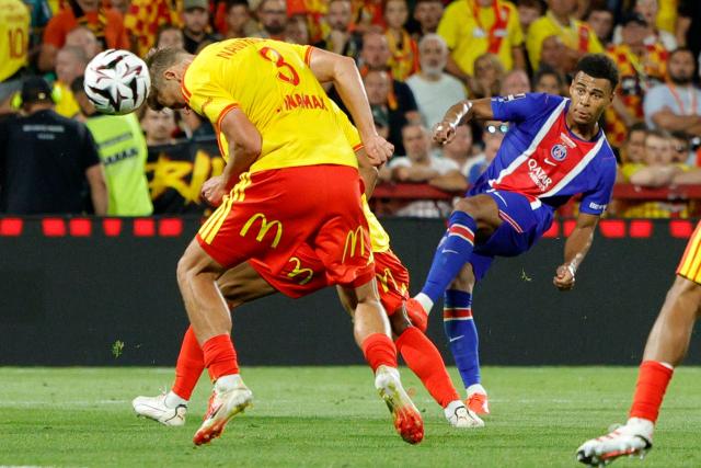 PSG's French forward #14 Desire Doue (R) shoots the ball past Lens' Polish defender #03 Maik Nawrocki during the French Super Cup (Trophee des Champions) football match between RC Lens and Paris Saint-Germain (PSG) at the Stade Bollaert-Delelis in Lens, northern France on August 16, 2026. (Photo by GEOFFROY VAN DER HASSELT / AFP)