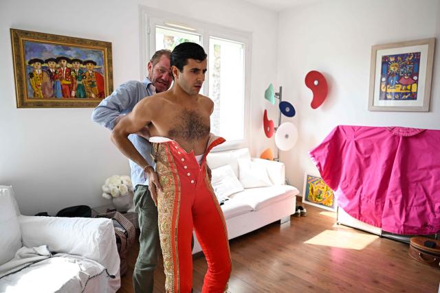 French matador Carlos Olsina is helped to adjust his bullfighter's pants ahead of a bullfight during the Feria in Beziers, southern France, on August 16, 2026. (Photo by Gabriel BOUYS / AFP)