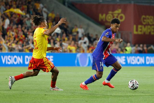 Lens' French defender #25 Ismael Ganiou (L) fights for the ball with PSG's French forward #14 Desire Doue during the French Super Cup (Trophee des Champions) football match between RC Lens and Paris Saint-Germain (PSG) at the Stade Bollaert-Delelis in Lens, northern France on August 16, 2026. (Photo by GEOFFROY VAN DER HASSELT / AFP)
