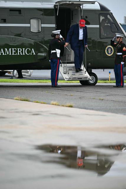 US President Donald Trump steps off Marine One as on his way to board Air Force One at Morristown Municipal Airport in Morristown, New Jersey, on August 16, 2026. President Trump is travelling back to Washington, DC, after spending the weekend at his golf club in New Jersey. (Photo by Kent NISHIMURA / AFP)
