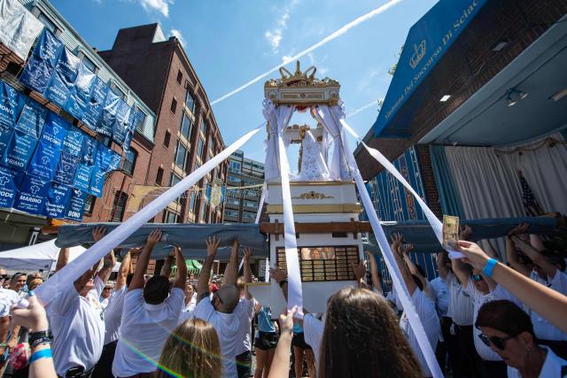 Members of the Maritime Society of the Madonna Del Soccorso Di Sciacca carry the statue of the Madonna del Soccorso di Sciacca as they march during a nine hour procession during the 116th Fisherman’s Feast Italian festival in Boston, Massachusetts on August 16, 2026. (Photo by JOSEPH PREZIOSO / AFP)
