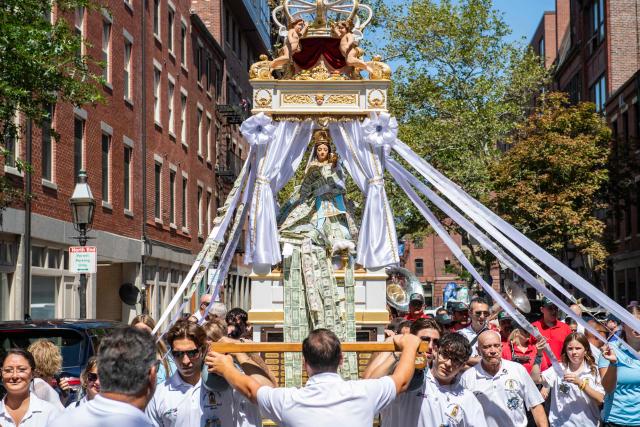 Members of the Maritime Society of the Madonna Del Soccorso Di Sciacca carry the statue of the Madonna del Soccorso di Sciacca as they march during a nine hour procession during the 116th Fisherman’s Feast Italian festival in Boston, Massachusetts on August 16, 2026. (Photo by JOSEPH PREZIOSO / AFP)