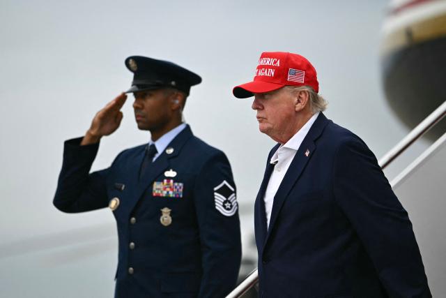 US President Donald Trump steps off Air Force One upon arrival at Joint Base Andrews in Maryland on August 16, 2026. President Trump is returning to Washington, DC, after spending the weekend at his golf club in New Jersey. (Photo by Kent NISHIMURA / AFP)