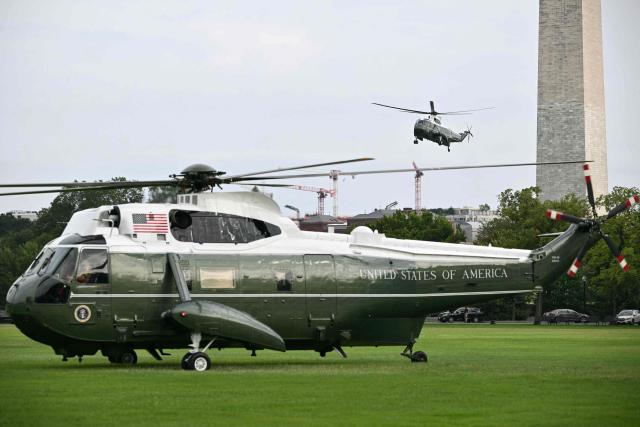Marine One (rear), with US President Donald Trump onboard, prepares to land on the Ellipse near the White House on August 16, 2026. President Trump is returning to Washington, DC, after spending the weekend at his golf club in New Jersey. (Photo by Mandel NGAN / AFP)