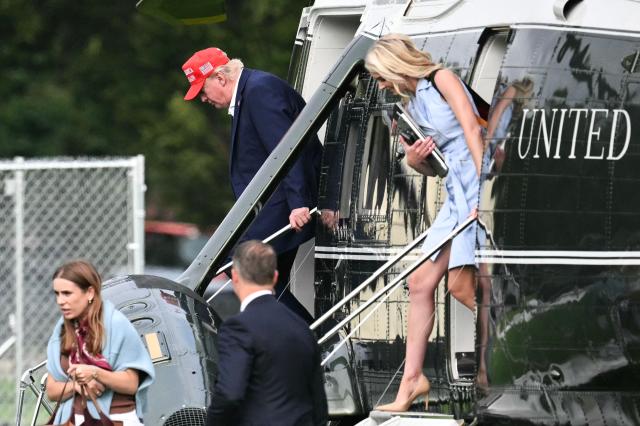 US President Donald Trump and aide Natalie Harp (R) exit Marine One on the Ellipse near the White House on August 16, 2026. President Trump is returning to the White House after spending the weekend at his golf club in New Jersey. (Photo by Mandel NGAN / AFP)