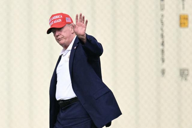 US President Donald Trump waves as he walks to his motorcade after exiting Marine One on the Ellipse near the White House on August 16, 2026. President Trump is returning to the White House after spending the weekend at his golf club in New Jersey. (Photo by Mandel NGAN / AFP)