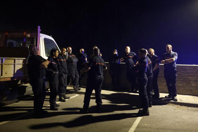 French firefighters from Perpignan unit prepare to battle fire in Santa Cruz de la Seros in the Spanish northeastern province of Aragon, in the night of August 16-17, 2026 amid a wildfire that burnt 16,600 hectares. A Spanish soldier died on August 16, 2026 while helping efforts to extinguish a major wildfire in the northeastern region of Aragon that has raged for a week and threatened a 1,000-year-old monastery. Regional authorities said more than 16,600 hectares had been affected and around 1,000 people evacuated from various small settlements and villages. (Photo by Oscar DEL POZO / AFP)