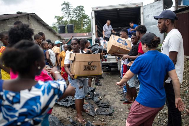Locals receive supplies after a 7.4 earthquake in Quibdo, Colombia on August 16, 2026. At least 287 people have died, thousands have been injured and about 379 remain unaccounted for, as the chances of finding earthquake survivors have dropped sharply since the critical 72-hour window passed, though volunteers and rescue crews continue digging through the rubble for any signs of life. (Photo by ESTEBAN VEGA LA-ROTTA / AFP)