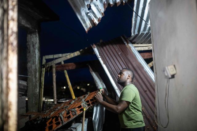 A man inspects his house after a 7.4 earthquake in Quibdo, Colombia on August 16, 2026. At least 287 people have died, thousands have been injured and about 379 remain unaccounted for, as the chances of finding earthquake survivors have dropped sharply since the critical 72-hour window passed, though volunteers and rescue crews continue digging through the rubble for any signs of life. (Photo by ESTEBAN VEGA LA-ROTTA / AFP)