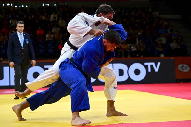 Italy's Gennaro Pirelli (blue) competes for gold against compatriot Daniele Accogli in the men's -100kg category final event, during the International Judo Federation (IJF) Lima Grand Prix 2026, in Lima, on August 16, 2026. (Photo by Ernesto BENAVIDES / AFP)