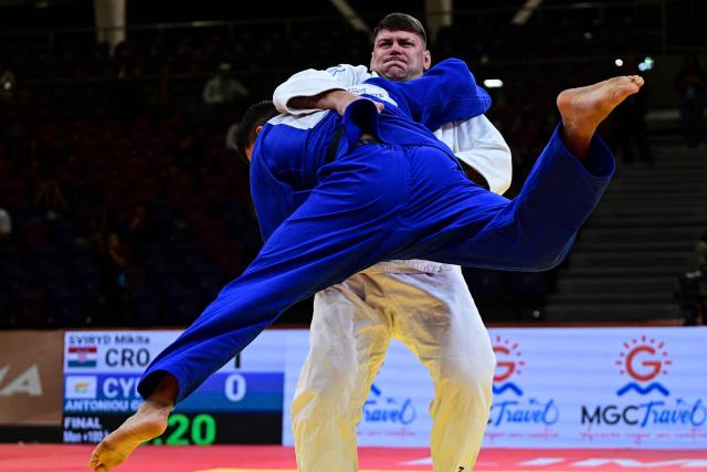 Cyprus' Giannis Antoniou (blue) competes for gold against Croatia's Mikita Sviryd in the men's +100kg category final event, during the International Judo Federation (IJF) Lima Grand Prix 2026, in Lima, on August 16, 2026. (Photo by Ernesto BENAVIDES / AFP)