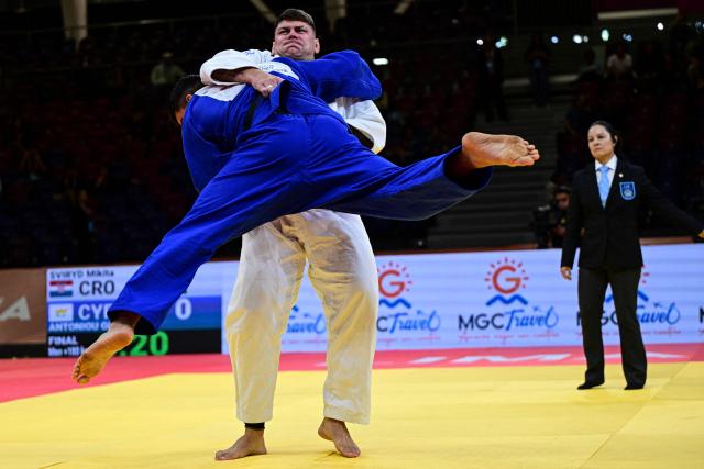 Cyprus' Giannis Antoniou (blue) competes for gold against Croatia's Mikita Sviryd in the men's +100kg category final event, during the International Judo Federation (IJF) Lima Grand Prix 2026, in Lima, on August 16, 2026. (Photo by Ernesto BENAVIDES / AFP)