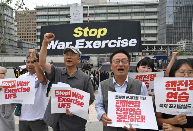 South Korean protesters hold placards as they attend a rally to oppose the joint military exercise between South Korea and the US named Ulchi Freedom Shield (UFS), in front of the US embassy in Seoul on August 17, 2026. South Korea's defence ministry said on August 17, that its joint military exercise with the United States has started after President Donald Trump's announcement it would be scaled back. (Photo by Jung Yeon-je / AFP)