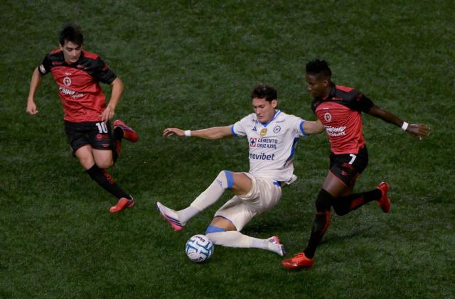 Cruz Azul's Argentine forward #20 Jose Paradela (C), Tijuana's midfielder #10 Gilberto Mora and Ecuadorian forward #07 Adonis Preciado fight for the ball during the Liga MX Apertura football match between Tijuana and Cruz Azul at Caliente stadium in Tijuana, Mexico on August 16, 2026. (Photo by Guillermo Arias / AFP)