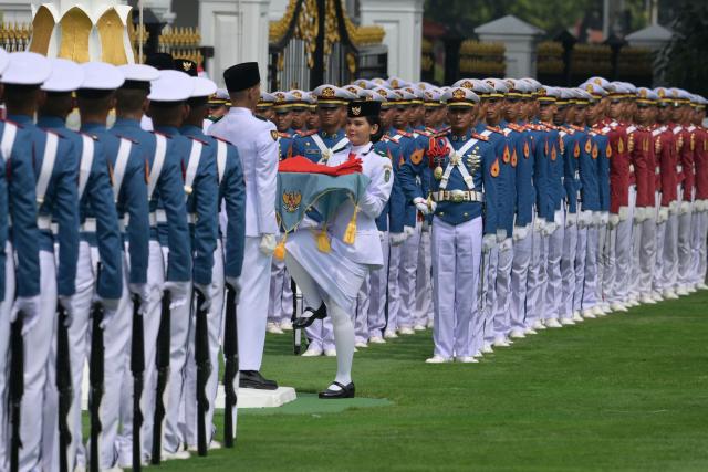 Military cadets take part in a flag raising ceremony marking Indonesia's 81st Independence Day at Merdeka Palace in Jakarta on August 17, 2026. (Photo by BAY ISMOYO / AFP)