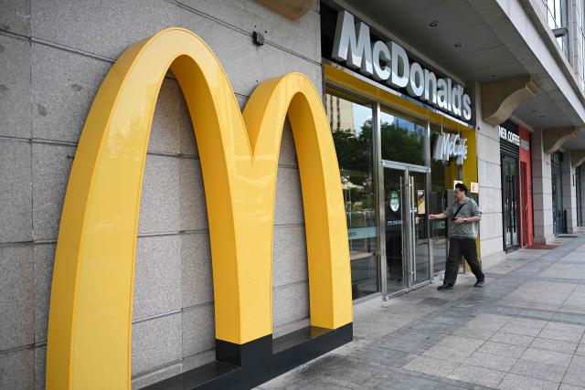 A customer enters a McDonald's branch in Beijing on August 17, 2026. (Photo by Pedro PARDO / AFP)