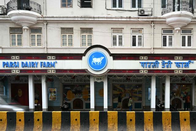 This photograph taken on August 1, 2026 shows the 110 year-old Parsi Dairy Farm which reopened after being closed down for food safety norms violation by Maharashtra's Food and Drug Administration (FDA) in Mumbai. When food safety inspectors raided a Mumbai dessert parlour famed for its ice cream sandwiches last month, they found rats, houseflies and expired flavouring agents. At another beloved restaurant known for slow-cooked mutton and beef stews, they discovered meat stored in filthy containers, greasy floors and open windows that could let in insects and crows. Both eateries were ordered shut in the toughest crackdown in years on restaurants in the megacity of more than 20 million people. The sweep has targeted everything from top eateries and luxury hotels to canteens at elite institutions, including the nearly century-old Cricket Club of India. (Photo by Indranil Mukherjee / AFP)