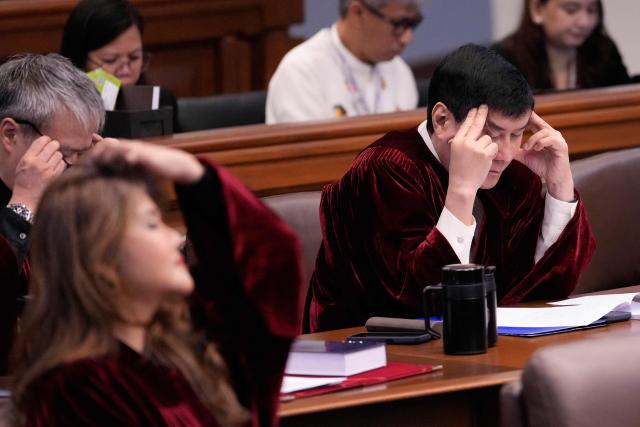 Senator Raffy Tulfo (R) reads a document during the impeachment trial of Philippine Vice President Sara Duterte in Pasay city, Metro Manila on August 17, 2026. (Photo by Aaron Favila / POOL / AFP)