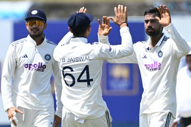 India's Manav Suthar (R) celebrates with captain Shubman Gill (L) and teammate Yashasvi Jaiswal (C) after taking the wicket of Sri Lanka's Dinesh Chandimal during the third day of the first Test cricket match between Sri Lanka and India at the Galle International Stadium in Galle on August 17, 2026. (Photo by Ishara S. KODIKARA / AFP)