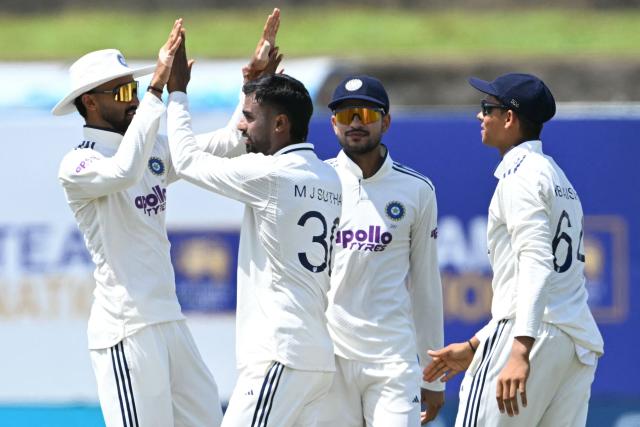 India's Manav Suthar (2L) celebrates with teammates after taking the wicket of Sri Lanka's Dinesh Chandimal during the third day of the first Test cricket match between Sri Lanka and India at the Galle International Stadium in Galle on August 17, 2026. (Photo by Ishara S. KODIKARA / AFP)