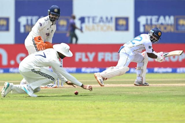 Sri Lanka's Lahiru Igalagamage (R) watches the ball after playing a shot during the third day of the first Test cricket match between Sri Lanka and India at the Galle International Stadium in Galle on August 17, 2026. (Photo by Ishara S. KODIKARA / AFP)