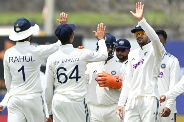 India's captain Shubman Gill (R) celebrates with teammates after the dismissal of Sri Lanka's Lahiru Igalagamage during the third day of the first Test cricket match between Sri Lanka and India at the Galle International Stadium in Galle on August 17, 2026. (Photo by Ishara S. KODIKARA / AFP)
