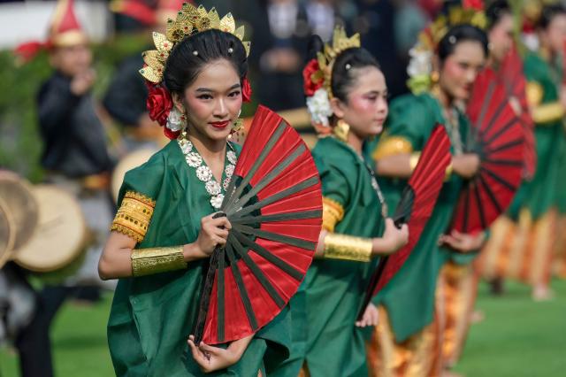 Dancers perform during a flag raising ceremony marking Indonesia's 81st Independence Day at Merdeka Palace in Jakarta on August 17, 2026. (Photo by BAY ISMOYO / AFP)