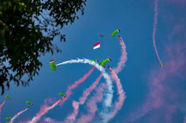 Skydivers perform during a flag raising ceremony marking Indonesia's 81st Independence Day above Merdeka Palace in Jakarta on August 17, 2026. (Photo by BAY ISMOYO / AFP)
