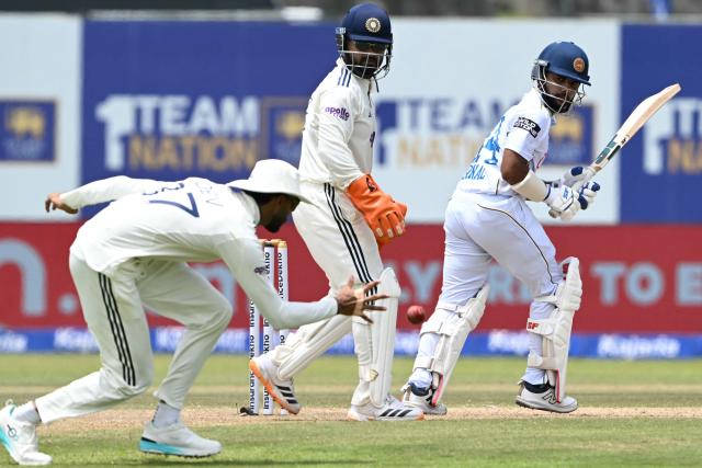 Sri Lanka's Sonal Dinusha (R) watches the ball after playing a shot during the third day of the first Test cricket match between Sri Lanka and India at the Galle International Stadium in Galle on August 17, 2026. (Photo by Ishara S. KODIKARA / AFP)