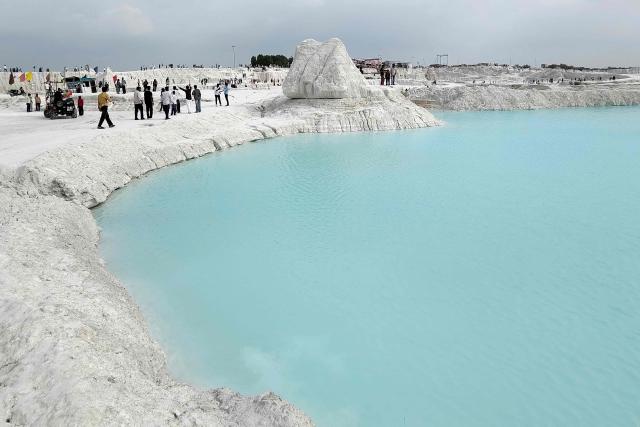 Tourists visit the marble-waste dumping yard in Rajasthan's Kishangarh city on August 16, 2026. A sprawling expanse of white marble waste in India is drawing tourists, filmmakers and social media enthusiasts to a landscape that looks more like a snow-covered valley than a dumping ground (Photo by Himanshu SHARMA / AFP)